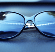 sunglasses resting on the panel of car