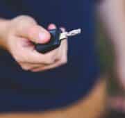 Mans hand holding car keys.