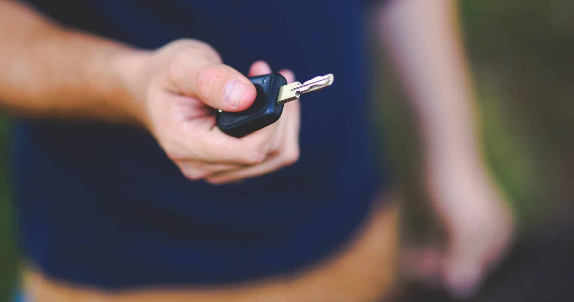 Mans hand holding car keys.