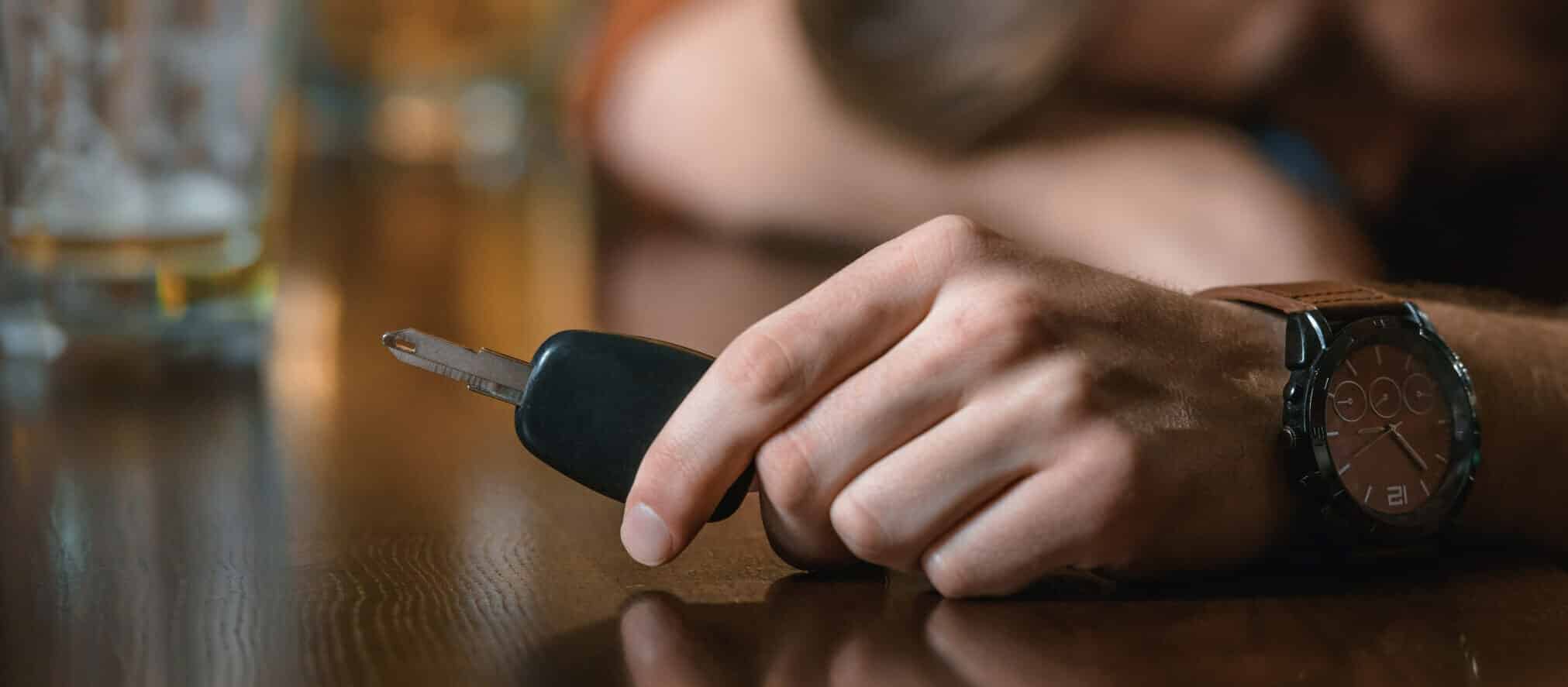 Man's hand holding car keys