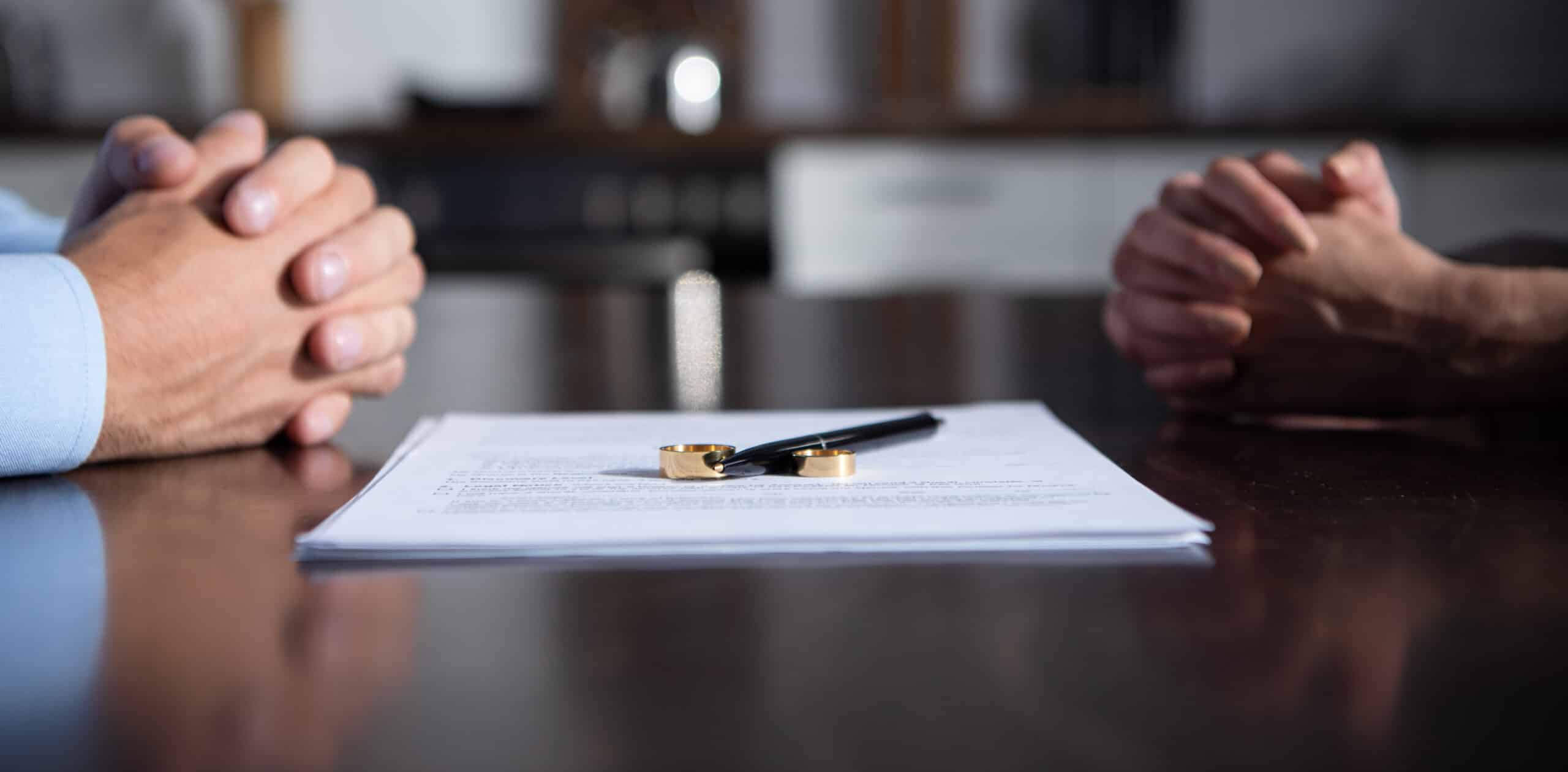 Hands of the parties in a no-fault divorce have finished signing the documents
