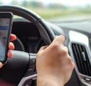 Person at the wheel of a car on the phone