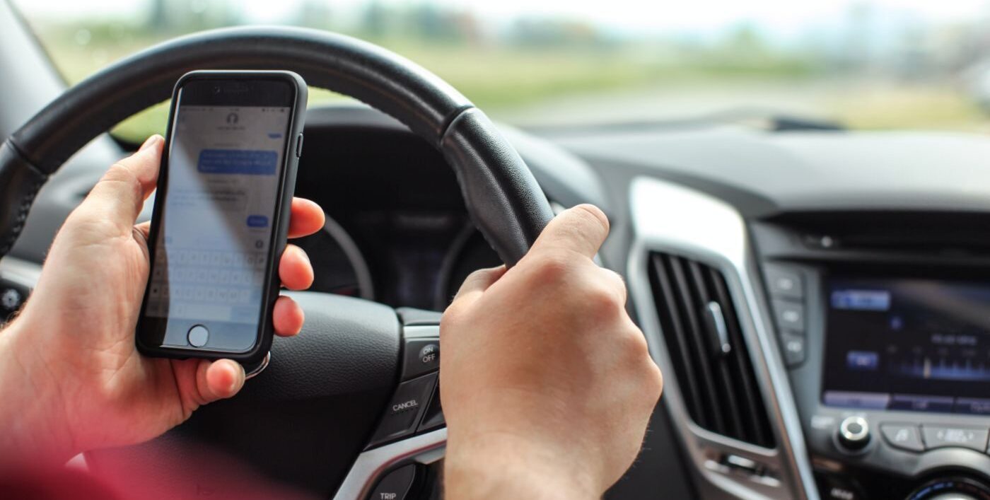 Person at the wheel of a car on the phone