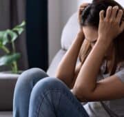 Lonely young asian woman felling depressed and stressed in living room at home, Negative emotion concept