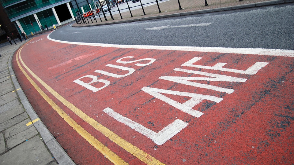 photo of red bus lane in England