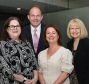 Four professionals at a Chamber event, including Alsters Kelley staff.