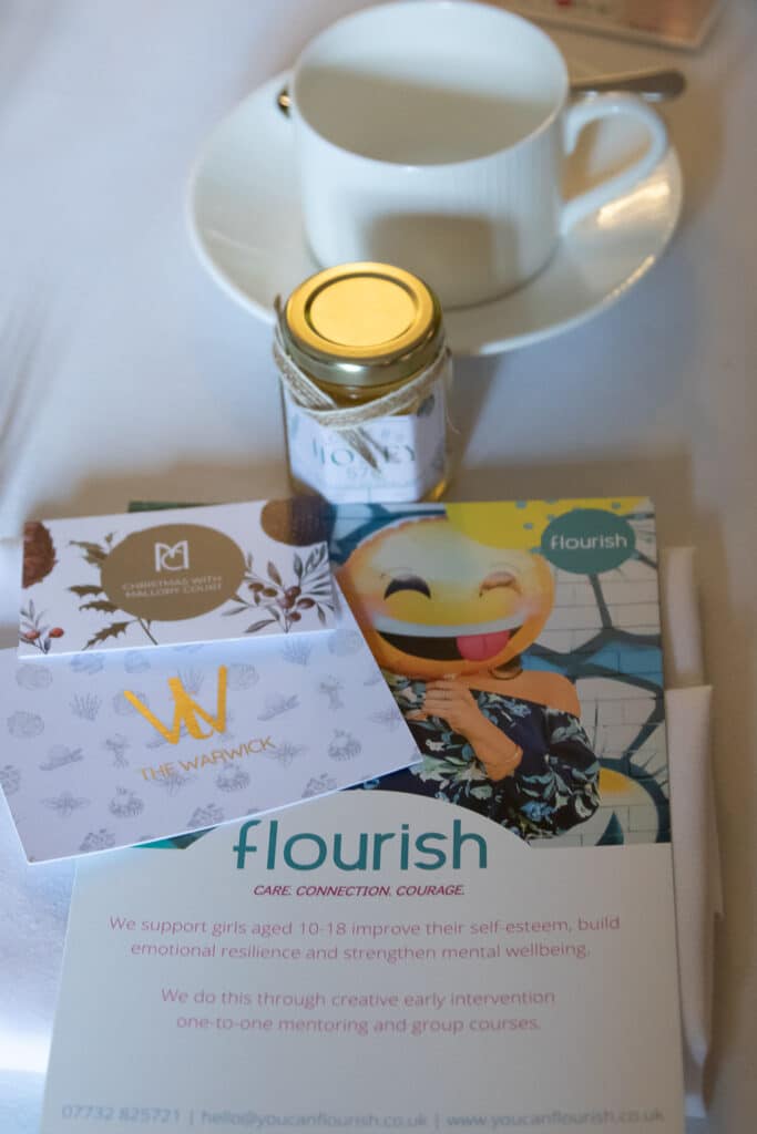 Flourish networking lunch event with tea, honey, and brochures.