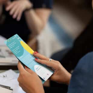Woman reads a brochure at Ladies First networking lunch event