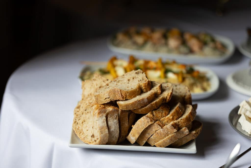 Sliced artisan bread on a plate at a networking lunch.
