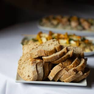Sliced artisan bread on a plate at a networking lunch.