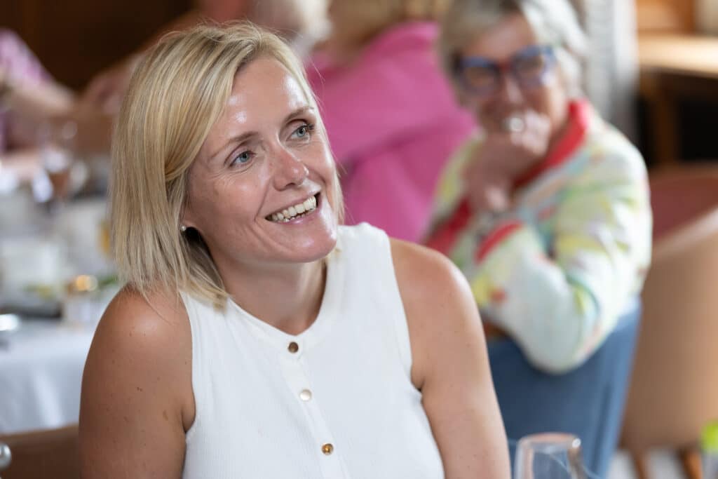 Woman smiling at a networking lunch event