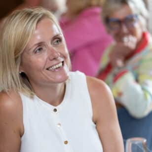 Woman smiling at a networking lunch event
