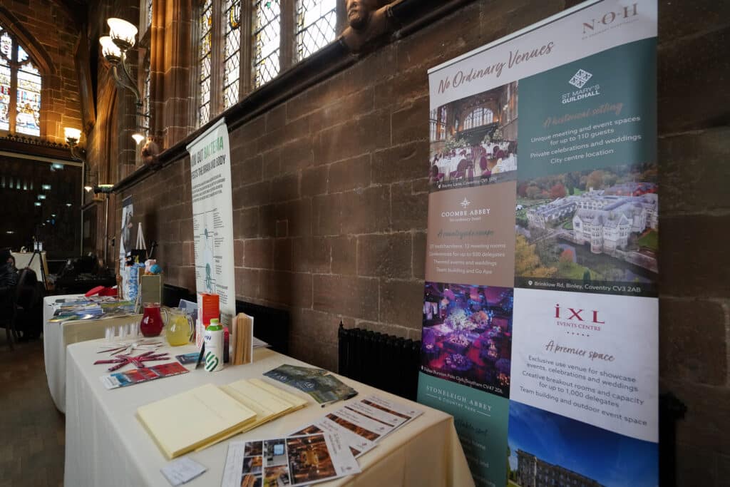 Event venue setup with brochures, flyers, and banners for Ladies First Networking