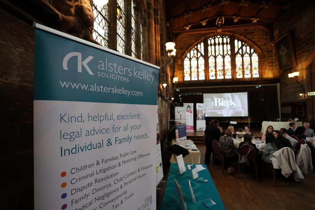 Alsters Kelley Solicitors banner for legal advice on display at a women's networking event.