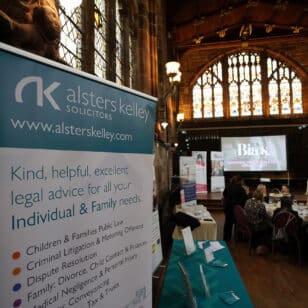 Alsters Kelley Solicitors banner for legal advice on display at a women's networking event.