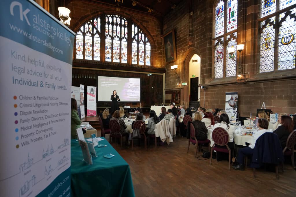 Ladies First Networking event in a historic hall with a woman presenting