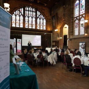 Ladies First Networking event in a historic hall with a woman presenting