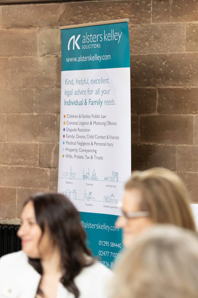 Alsters Kelley solicitors banner with services list at Ladies First Networking event