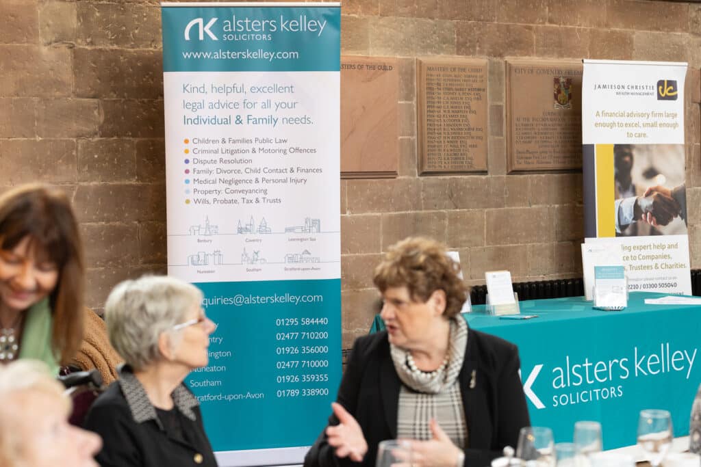 Women at Ladies First Networking event in 2026, Alsters Kelley banner in background