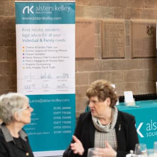 Women at Ladies First Networking event in 2026, Alsters Kelley banner in background