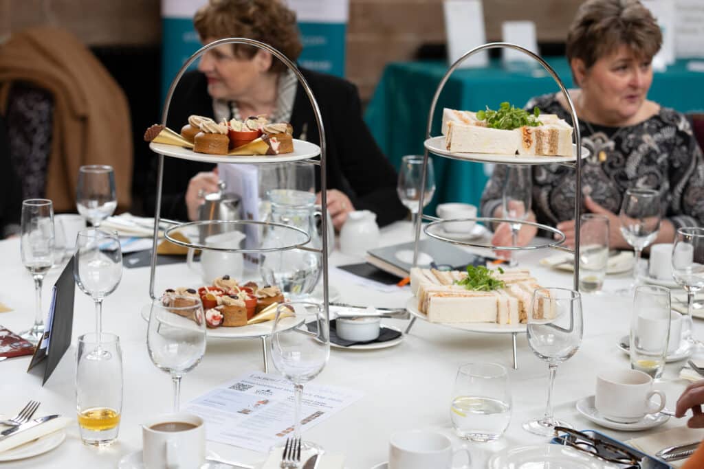 Ladies First Networking event with sandwiches and pastries on three-tier stands