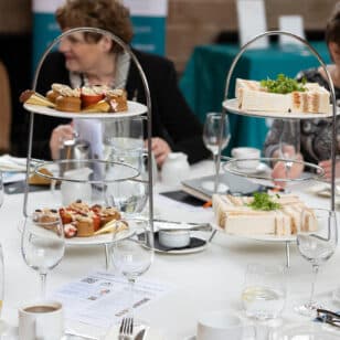 Ladies First Networking event with sandwiches and pastries on three-tier stands