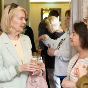 Women at Lafies First Lunch event in June 2026, chatting and holding champagne glasses.